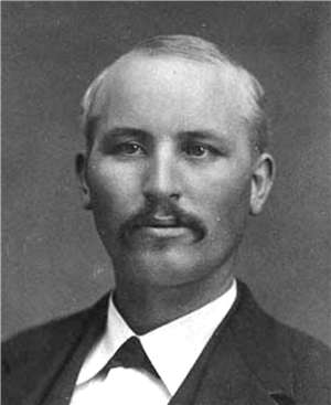 A portrait of a young white man in a suit